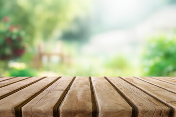 Wooden table or surface with blurred summer forest background