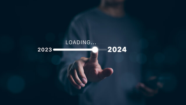 Man hand touching loading bar for countdown to 2024. In progress loading year 2023 to 2024, Planning and challenge business strategy in new year, Countdown merry Christmas and Happy New Year, Startup,