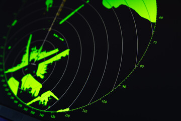 Radar screen with green digital indication on black background, close-up photo
