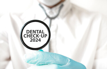 Doctor holding a stethoscope with text DENTAL CHECK UP 2024, medical concept