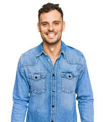 Young hispanic man wearing casual denim jacket with a happy and cool smile on face. lucky person.