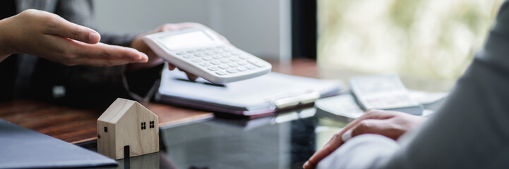 Home loan insurance. .Real estate broker and client sign contract insurance agreement document....