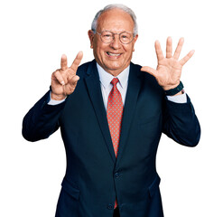 Senior man with grey hair wearing business suit and glasses showing and pointing up with fingers number seven while smiling confident and happy.