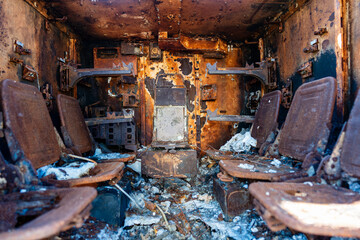 Inside view of burnt-out military infantry fighting vehicle. Burning military vehicles on...