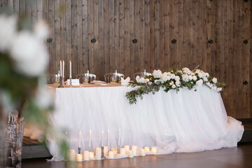 Main table at a wedding reception with beautiful fresh flowers. Wedding day.