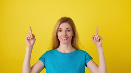 Woman and pointing at mockup workspace for advert, marketing, promotion or text. Fashionable model happy smiling showing mock up for advertisement, news deal of offer in studio on yellow background