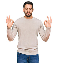 Young hispanic man wearing casual clothes relax and smiling with eyes closed doing meditation gesture with fingers. yoga concept.