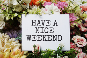 Have a nice Weekend text message on paper card with beautiful flowers decoration