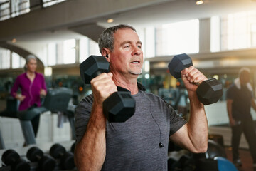 Old man, senior fitness and dumbbells at a gym for weightlifting, challenge or workout, training or...