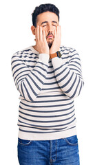 Young hispanic man wearing casual clothes tired hands covering face, depression and sadness, upset and irritated for problem