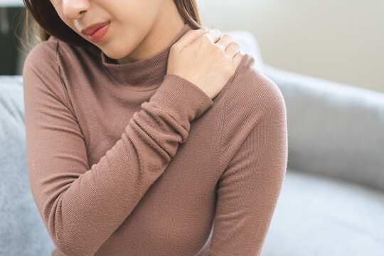 Young caucasian woman in bra with pain in shoulders and neck, ache in the  human body, isolated on white background Stock Photo