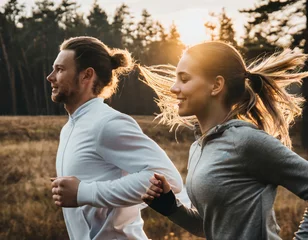 Gordijnen Morning running. Man and woman jogging © SashaMagic