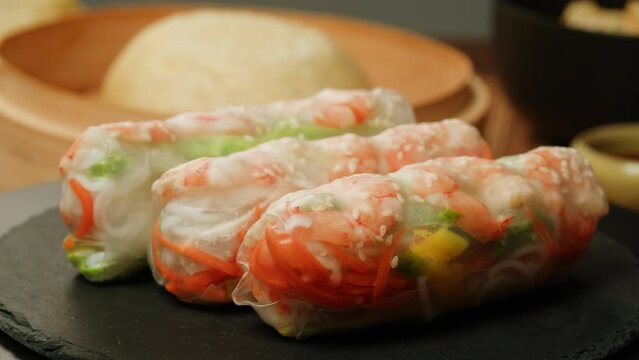 Spring roll with shrimps and vegetables inside close-up macro. Shrimp roll with rice papper. Cooking Fresh Vietnamese Spring Rolls. Healthy food.