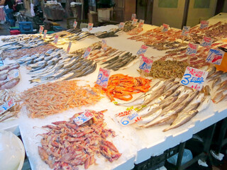 fishmongers counter at the fish market with names in Italian and prices in euros in southern Italy