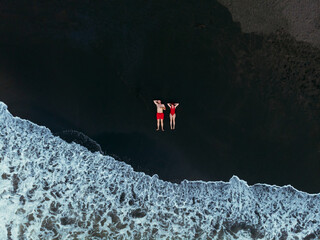 Black sand beach. Fantastic landscape of black sand volcano Ureki beach in Georgia. Couple having a...