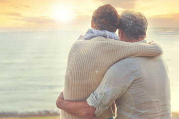 Old couple, hug and sunset on sea at the beach with care, support and trust in marriage or...