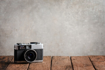 Retro camera on wooden board with copyspace