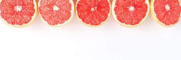 Fresh grapefruits on white table with copyspace