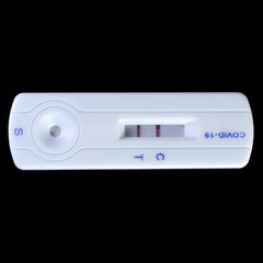 Positive rapid test for coronavirus on a black background