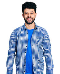 Young arab man with beard wearing casual shirt with a happy and cool smile on face. lucky person.