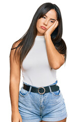 Young beautiful hispanic girl wearing casual clothes thinking looking tired and bored with...