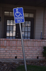 A parking signage or board for handicap persons only at a society in USA