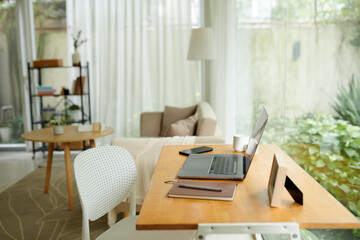 Planner, laptop and smartphone on desk in home office area