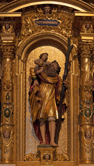 LUZERN, SWITZERLAND - JUNY 24, 2022: The carved polychrome side altar of St. Cristopher in the church St. Leodegar im Hof by Niklaus Geisler (1585-1665)