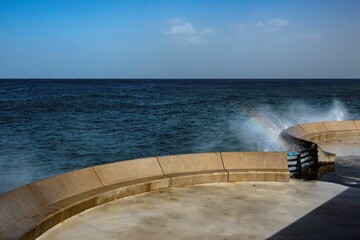 waves of the Mediterranean sea breaking on a barrier at the coast of Beirut