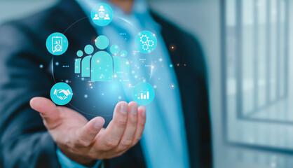 Businessman holding human icon. Customer Relationship Management Business Internet Technology Concept. Businessman hand holding human icon for customer value and customer relation management concept.