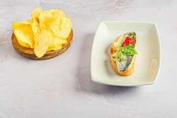 Small platter with a marinated sardine canapé