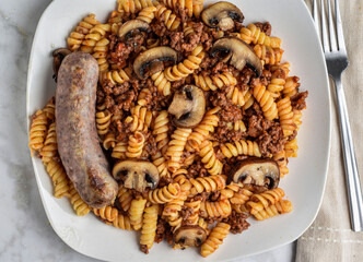 rotini  pasta with a meat sauce  and italian sausage