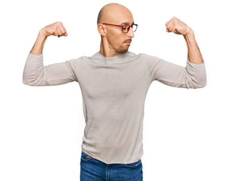 Bald man with beard wearing casual clothes and glasses showing arms muscles smiling proud. fitness concept.