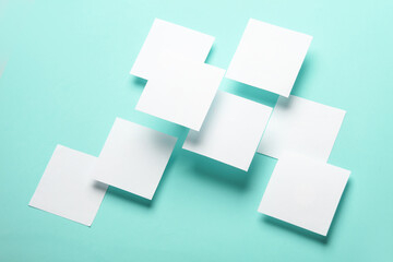 Composition of floating white square memo papers on blue background. Business concept