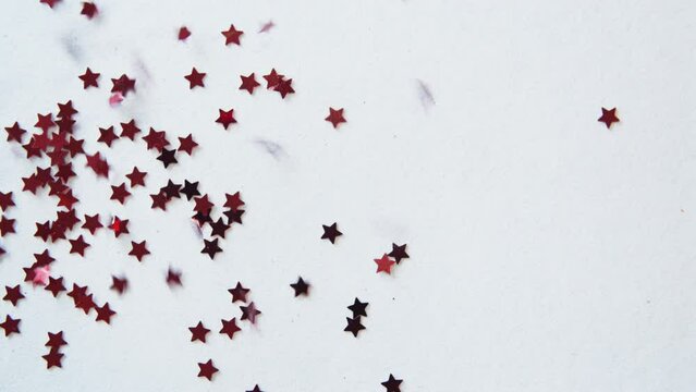 Red stars fall on white background. Happy new year, Traditional lunar year background. Copy space. Confetti. Holiday greeting frame. Glamorous Red Star Falling. Confetti Glitter Rain.