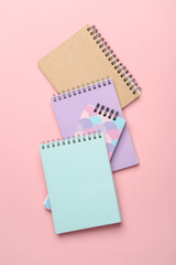 Different notepads on a pink background