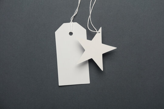 White blank tags with string on gray background
