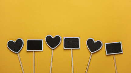 Chalkboard labels, blank wooden blackboard tags, garden sign on yellow background