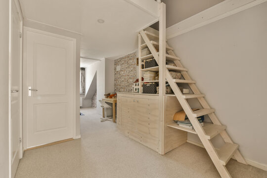 Wooden ladder next to storage in hallway