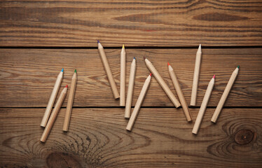 Set of wooden colored pencils on wooden background. Creativity, art