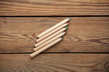 Set of wooden colored pencils on wooden background. Creativity, art