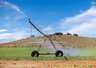 Irrigation system watering crops on a sunny day
