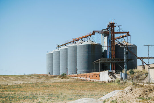 Industrial silos in a rural landscape under blue sky