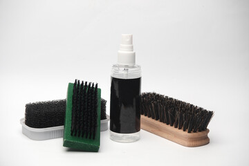 Shoe brushes and protection spray on a white background. Footwear care
