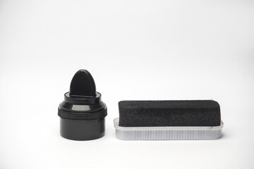 Shoe polish jar with sponge on white background
