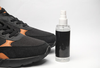 Sneakers and water protection spray on white background. Shoe care