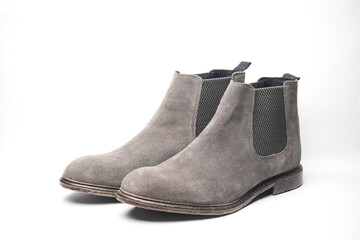 Pair of gray suede Chelsea boots on a white background