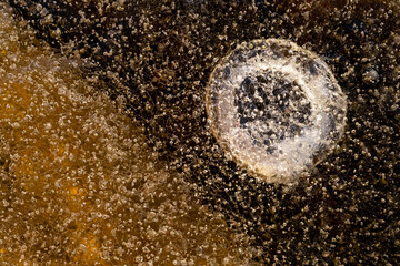 Top view of Frozen water with cracks in winter