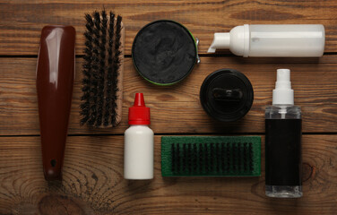 Shoe care products and accessories on wooden background. Top view. Flat lay