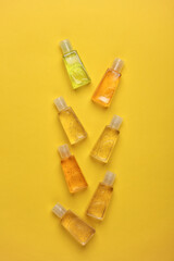 Antiseptic bottles on yellow background. Top view